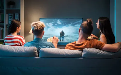top iptv providers friends watching movies together at home 2026